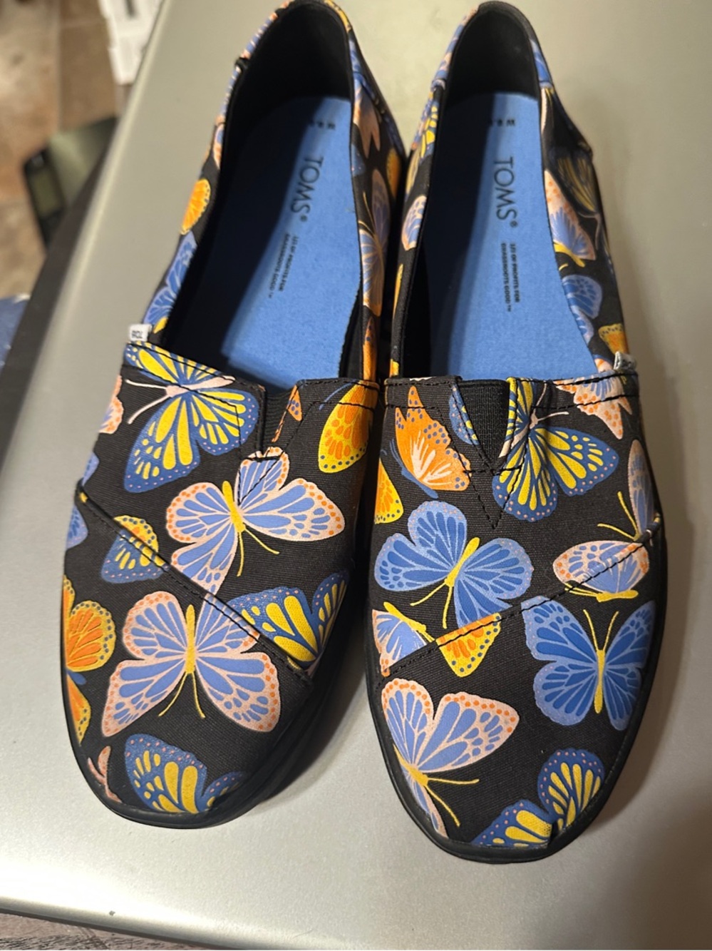 Toms Black Slip-On Shoes with Blue and Orange Butterfly Print size 8.5